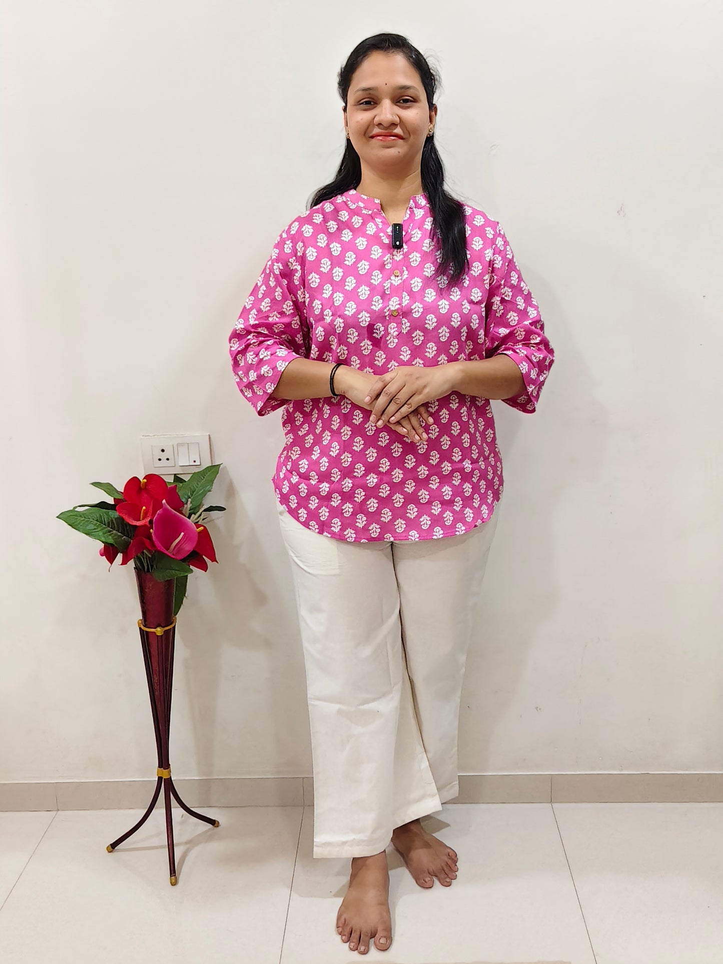 Elegant pink patterned cotton short kurti for women paired with white pants