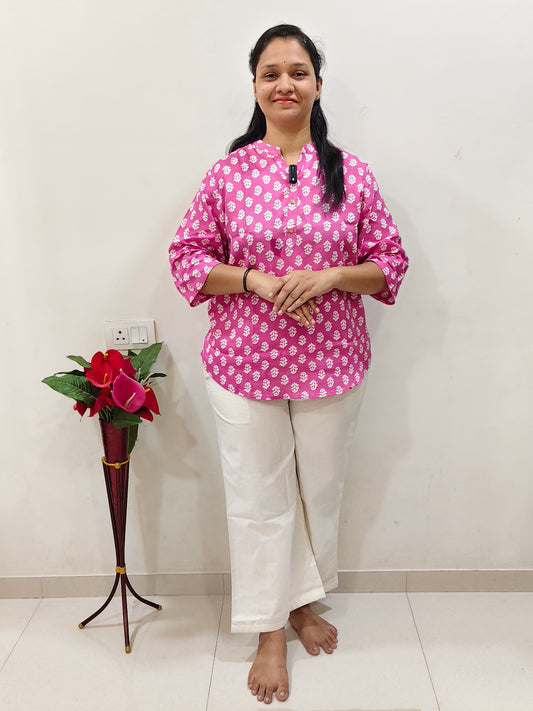 Elegant pink patterned cotton short kurti for women paired with white pants