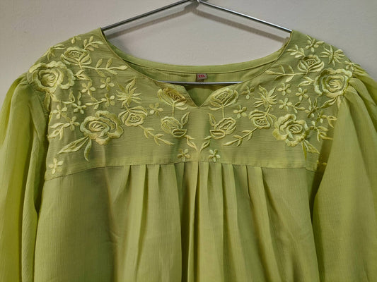 Elegant lemon yellow short kurti with floral embroidery detail on the neckline and pleated design