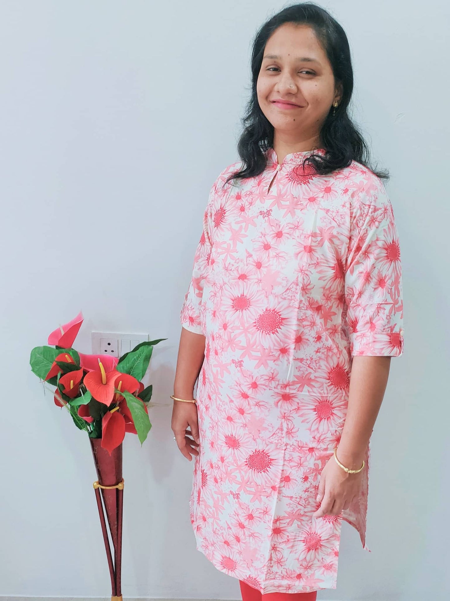 Women wearing a premium rayon kurti in pink floral design, perfect for casual outings and summer occasions