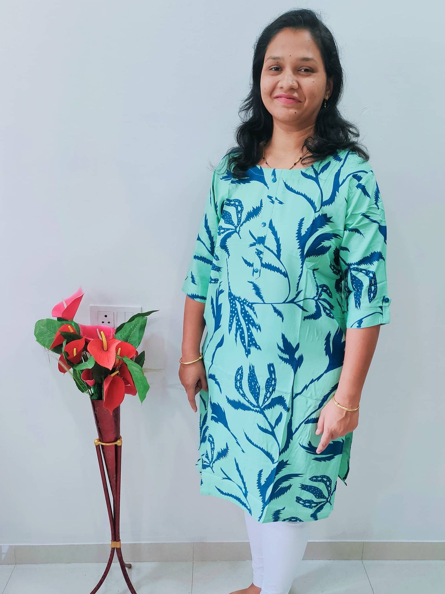 Model wearing a premium rayon kurti with pocket in green floral design, perfect for casual wear