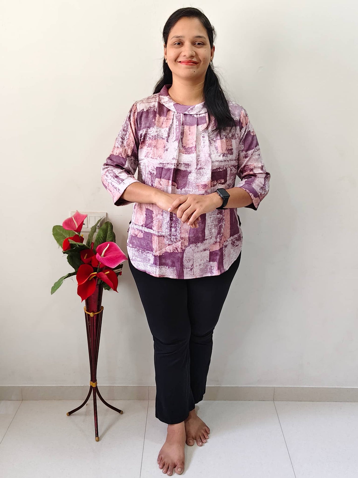 Elegant Collections printed casual top for women in abstract design paired with black pants