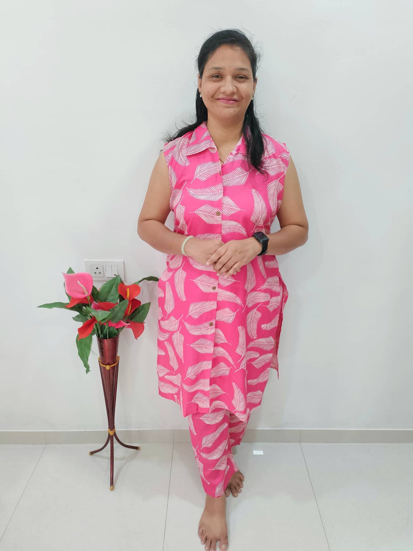 Elegant Rani pink cord set featuring a floral sleeveless kurta and matching leggings