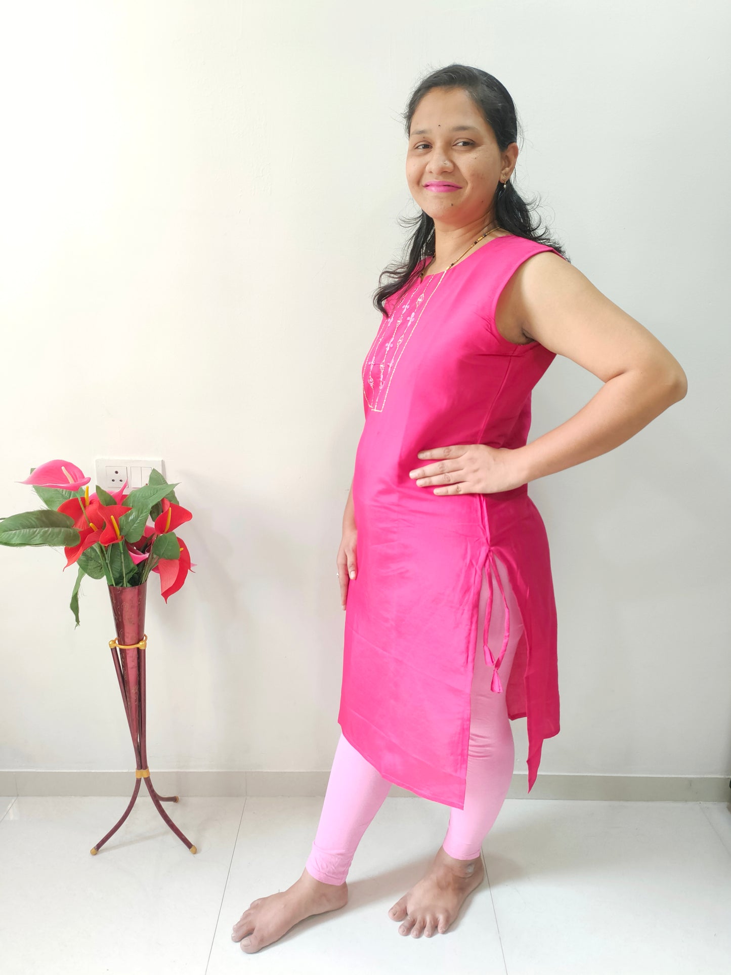 Woman modeling Rani Pink Cotton Silk Kurti paired with leggings for a stylish ethnic look