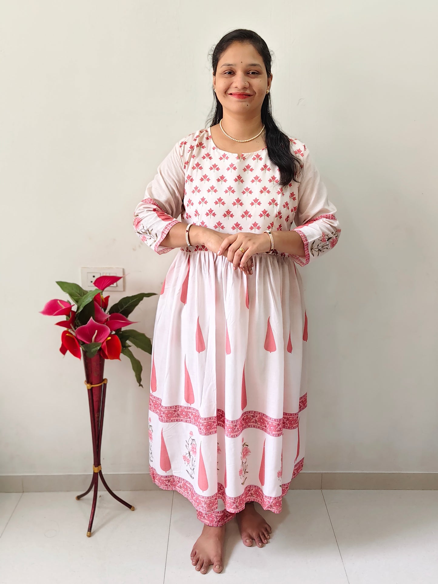 Elegant Collections umbrella type kurti pant set in pink and white with floral patterns and long sleeves