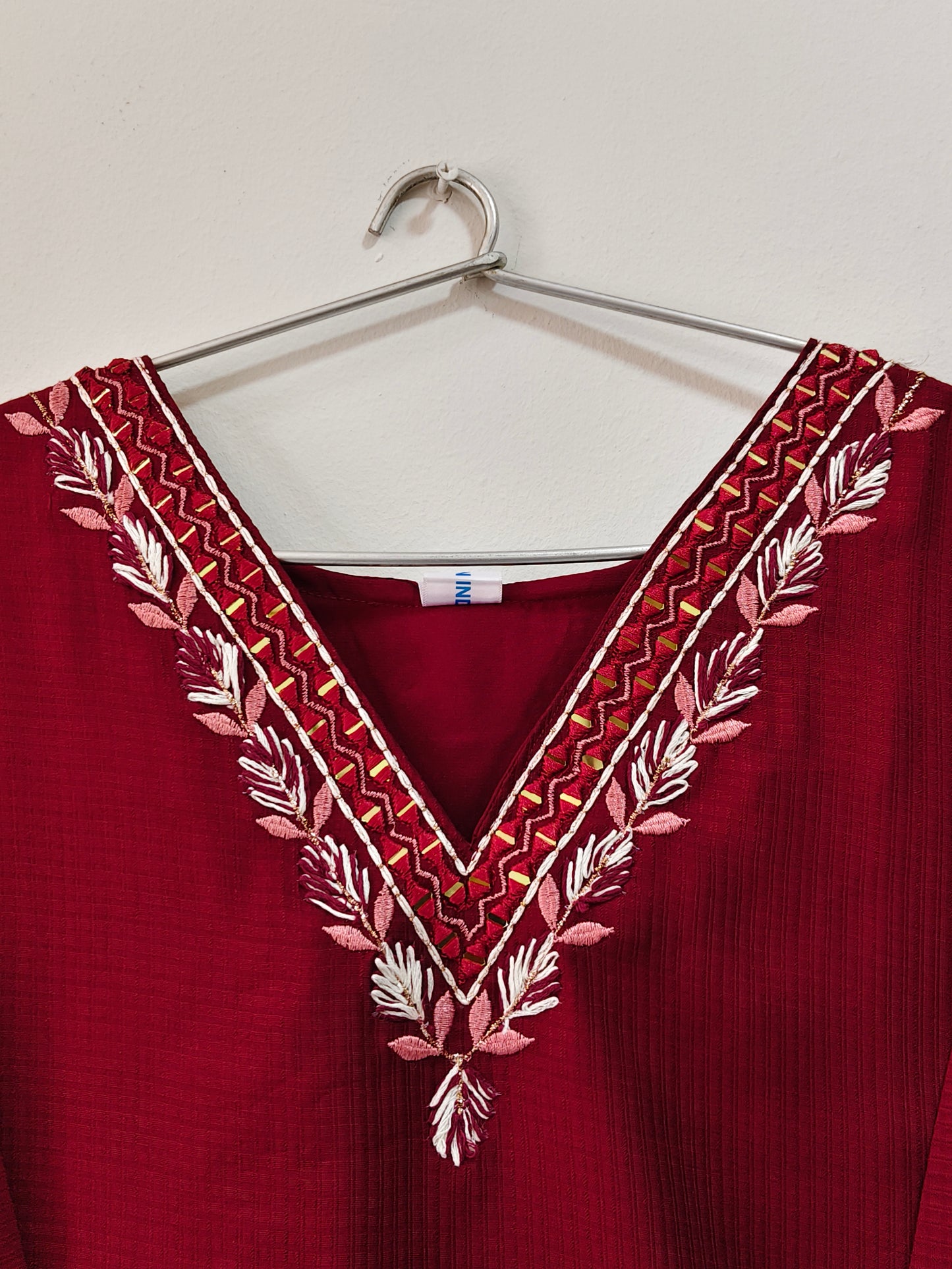 V-Neck Designer Kurti in burgundy with intricate floral embroidery on neckline