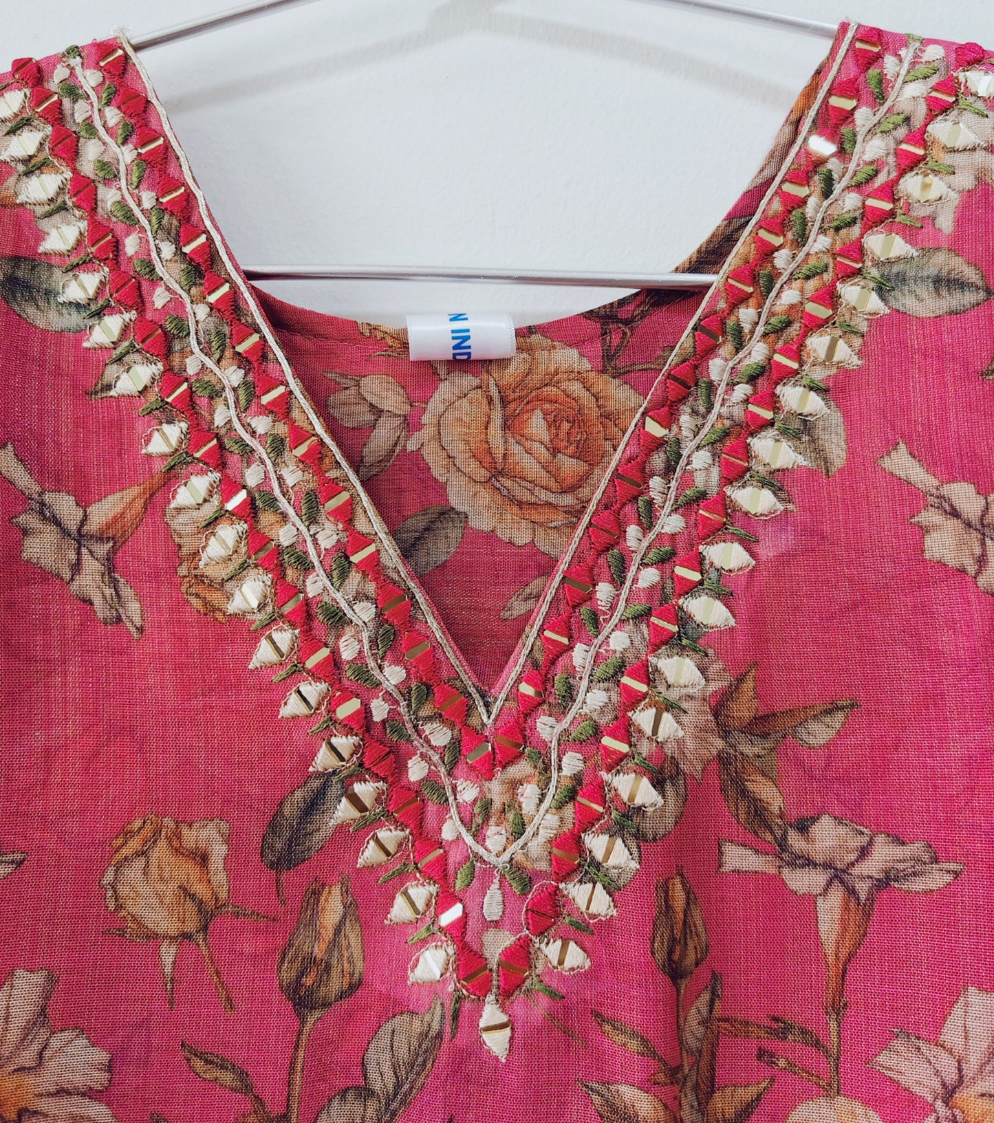 Elegant V-neck mirror work kurti with floral pattern and intricate embroidery details