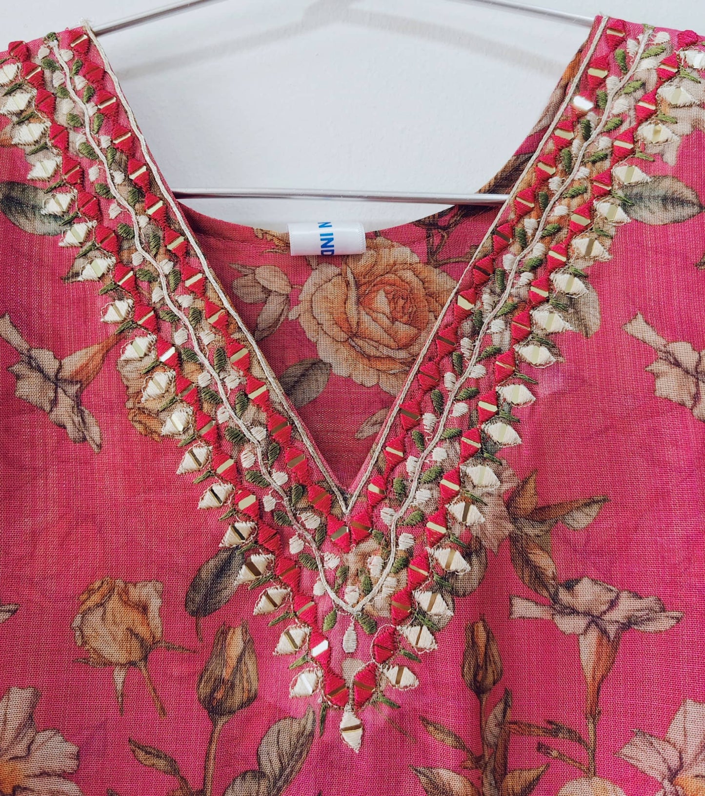 Elegant V-neck mirror work kurti with floral pattern and intricate embroidery details