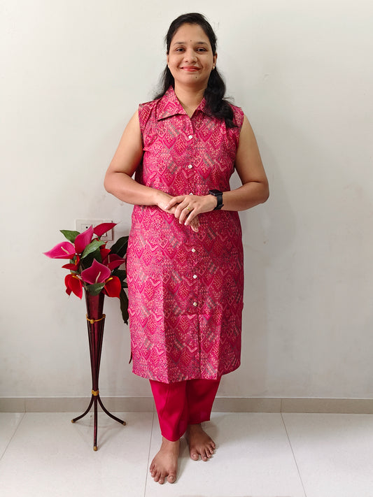 Woman wearing a sleeveless printed vetican fabric pink cord sets with Show button-down front and pink colour plazzo