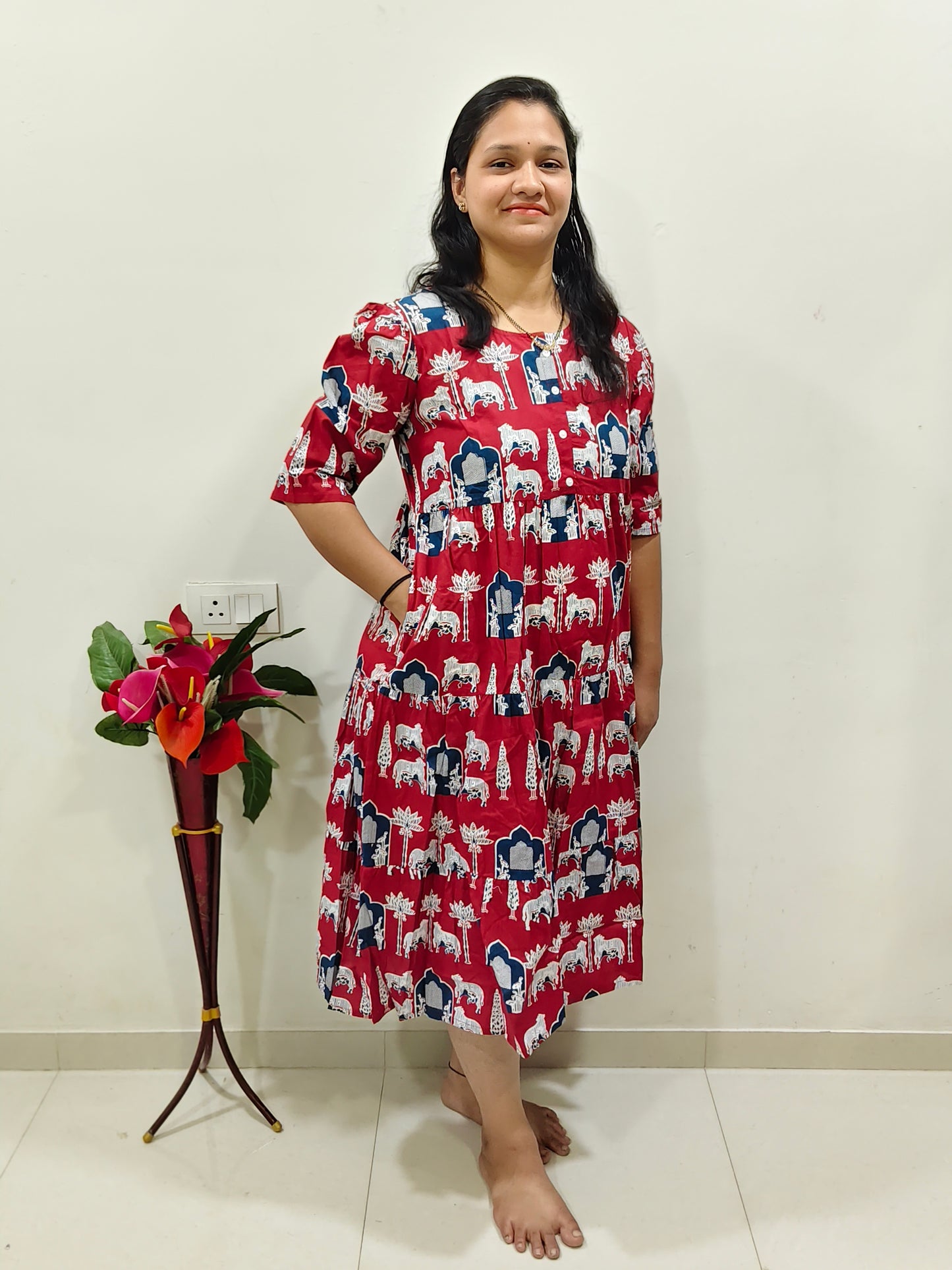 Elegant red cotton dress for summer featuring a floral print and comfortable fit, ideal for warm weather outings