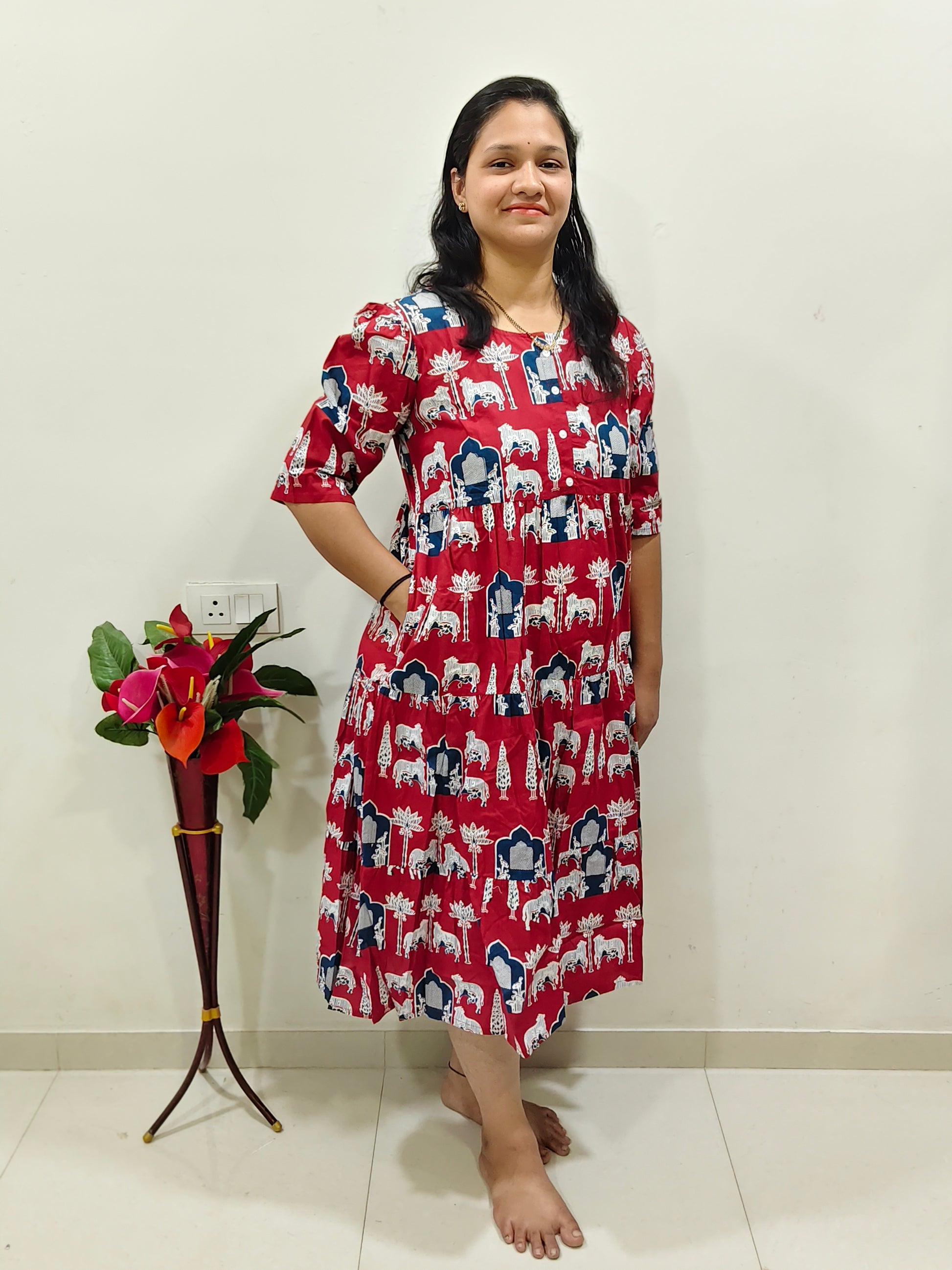 Elegant red cotton dress for summer featuring a floral print and comfortable fit, ideal for warm weather outings