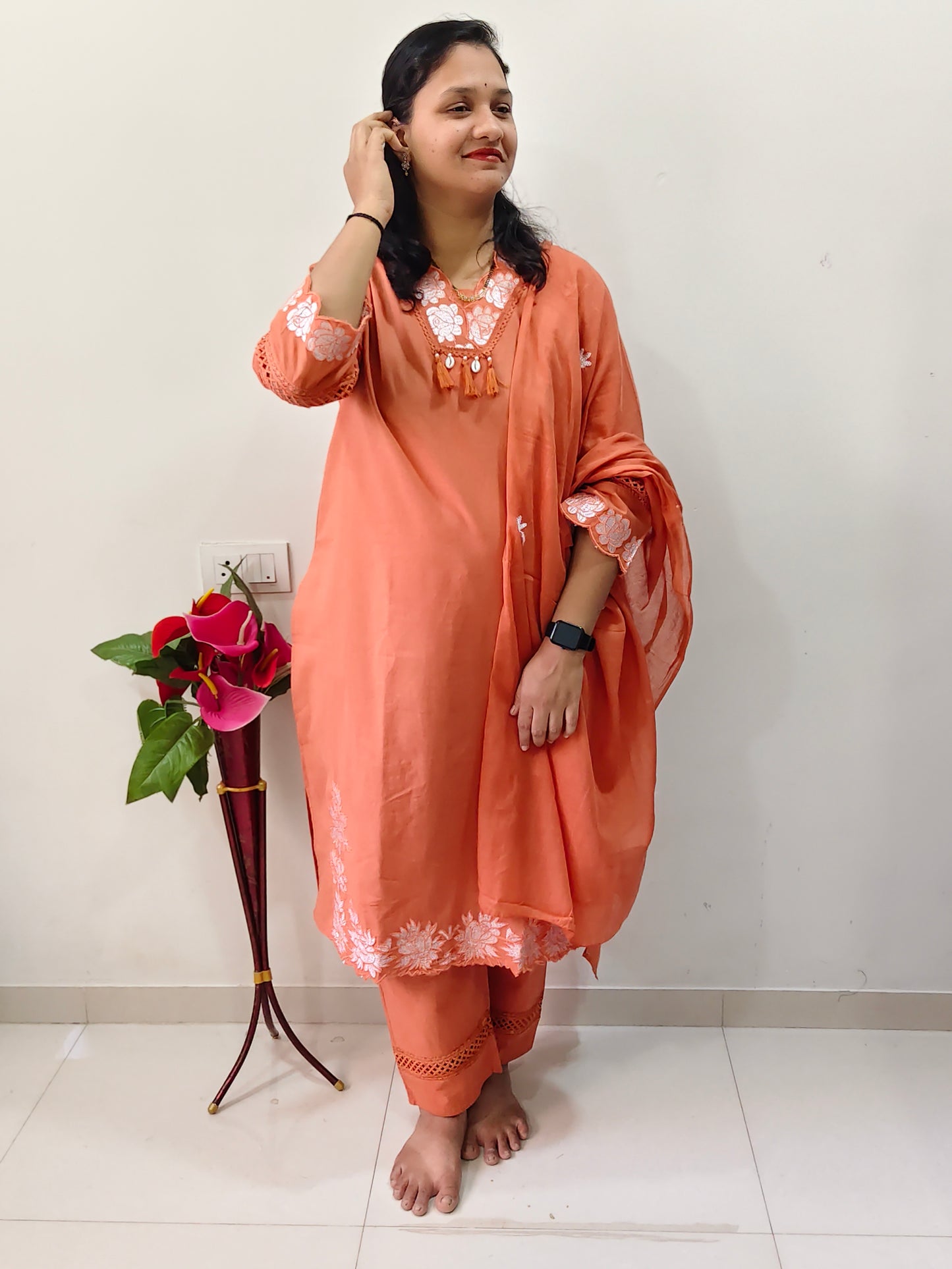 Elegant cotton salwar suit in peach color with floral embroidery, perfect for casual occasions.