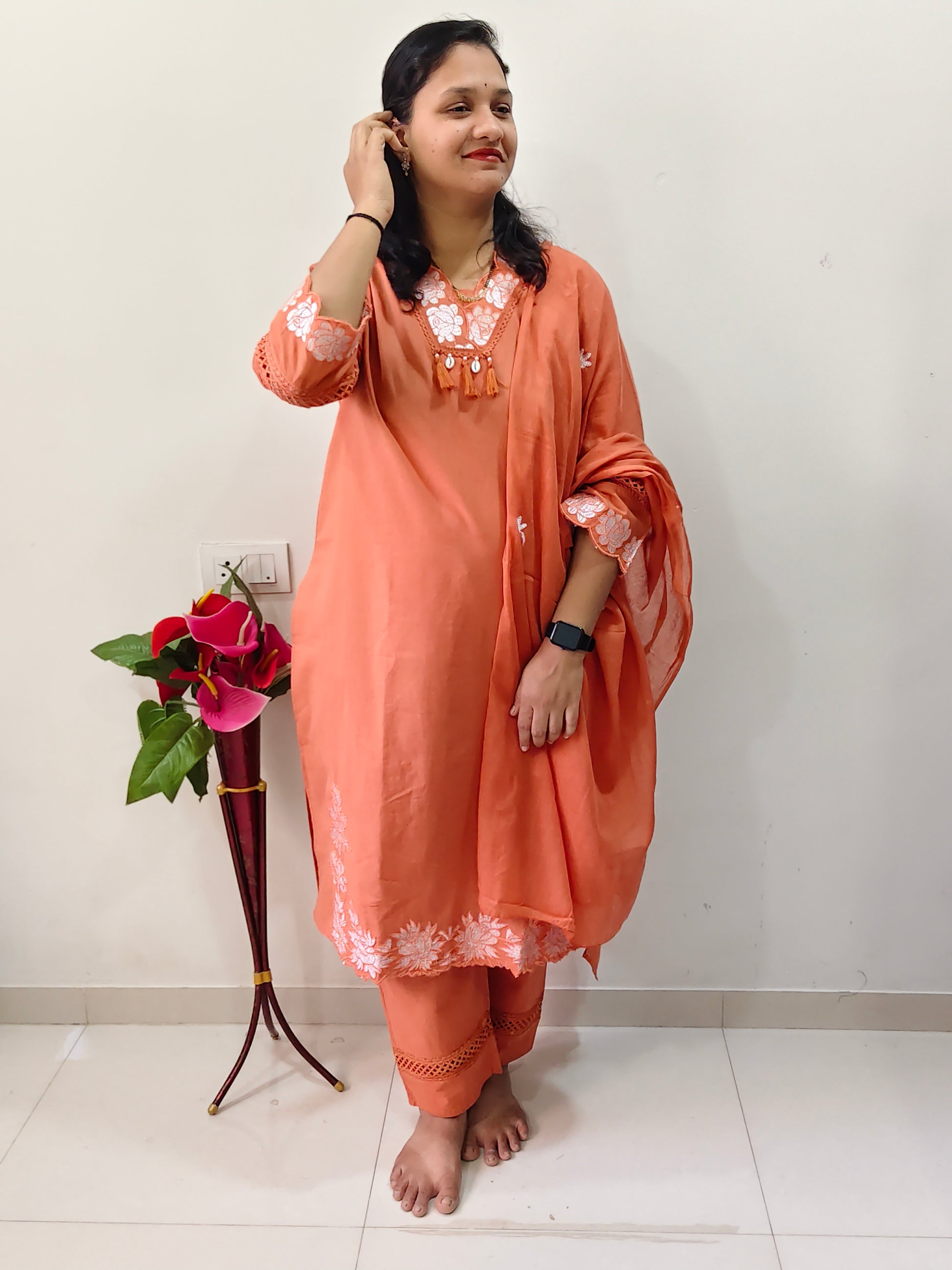 Elegant cotton salwar suit in peach color with floral embroidery, perfect for casual occasions.
