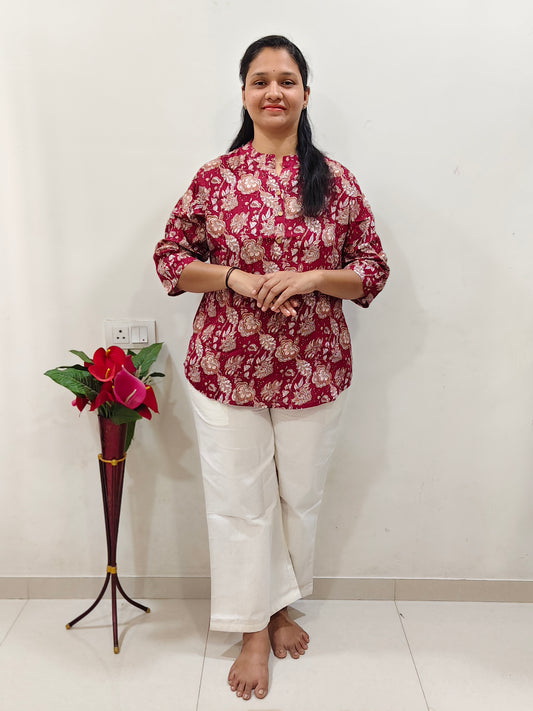 Elegant Collections Cotton Short Kurti in Floral Cherry Red paired with white trousers for a stylish look