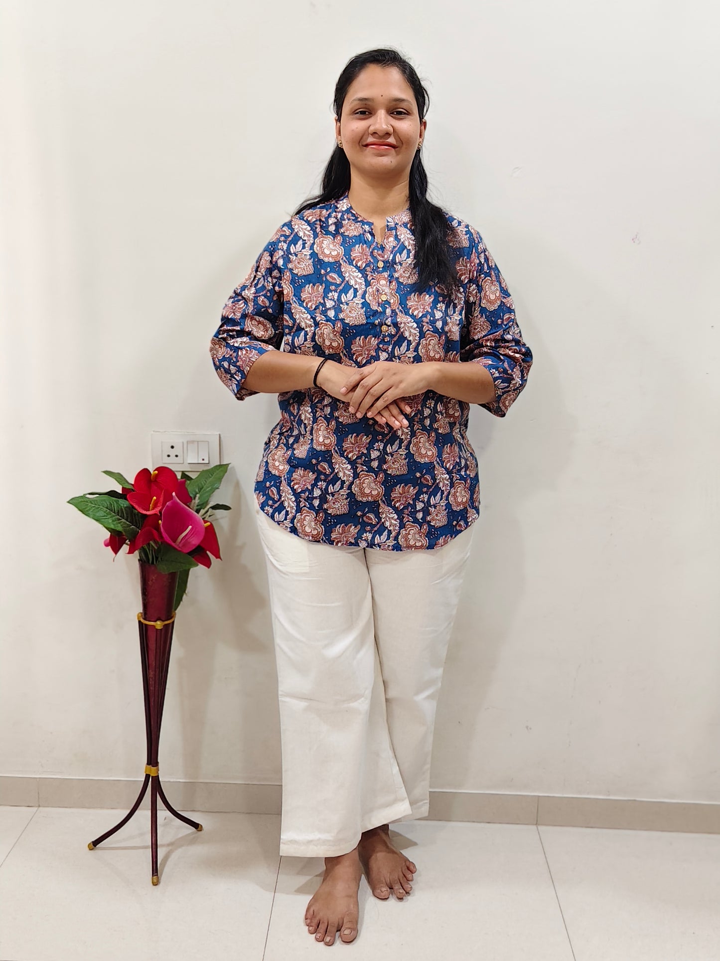 Elegant navy cotton short kurti for women with floral print, paired with white pants