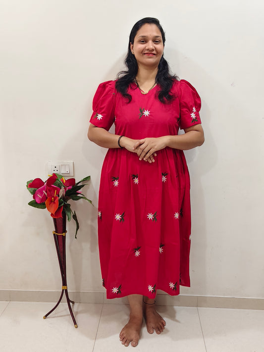 Elegant Collections dress embroidered in vibrant pink with floral designs and short puff sleeves