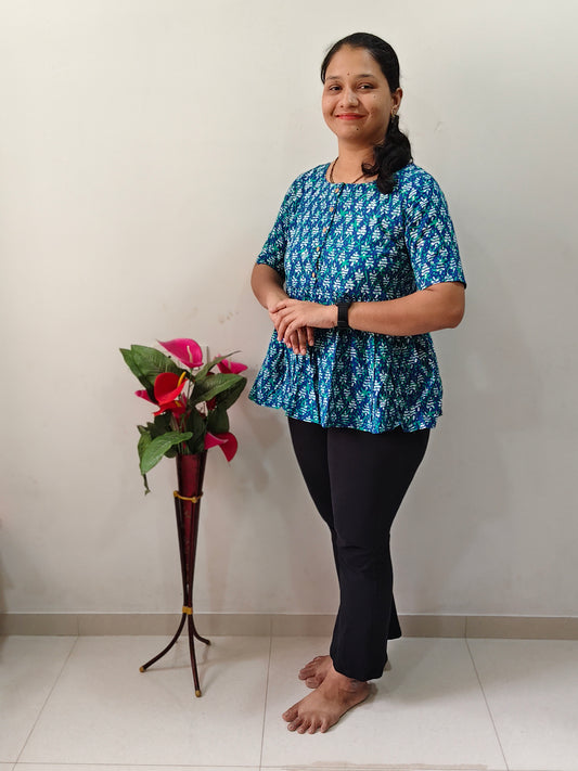 Stylish greenish blue peplum kurti paired with black leggings for a chic casual look