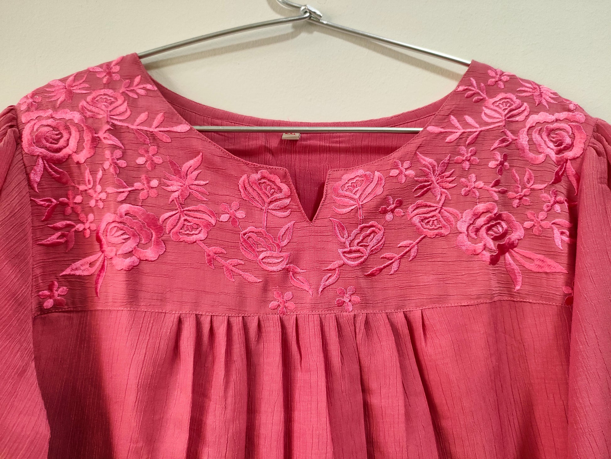 Onion pink short kurti with floral embroidery and a round neckline for stylish casual wear