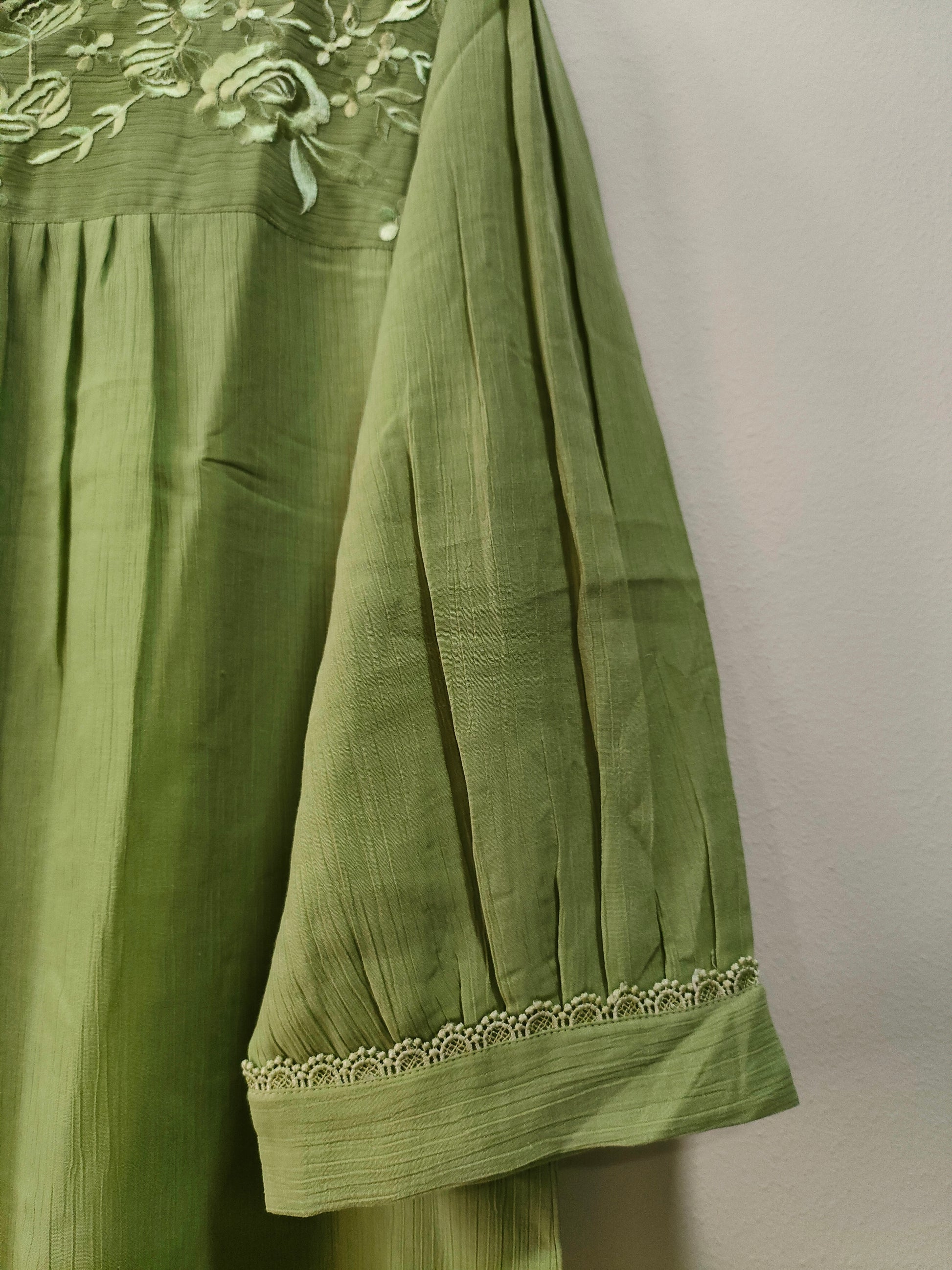 Elegant light green pista short kurtis with floral embroidery and stylish puffed sleeves